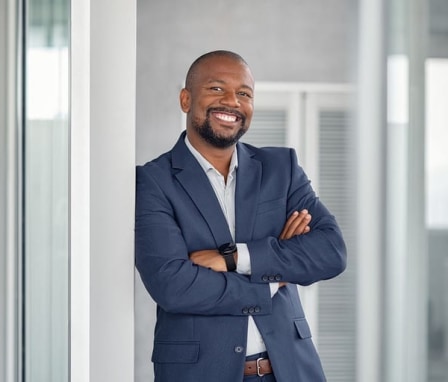 Man in suit smiling and posing for camera