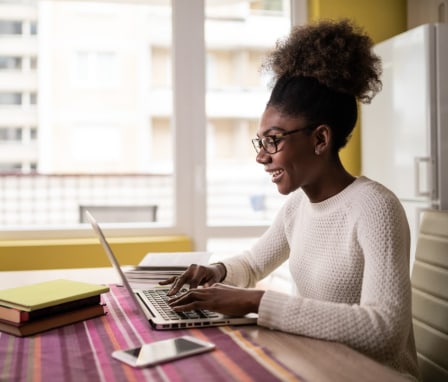 Woman smiling and typing on computer